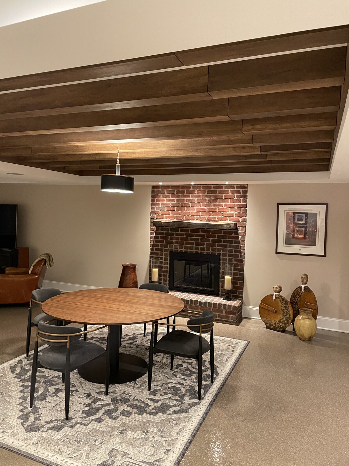 Dining area with custom walnut plank ceiling and brick fireplace