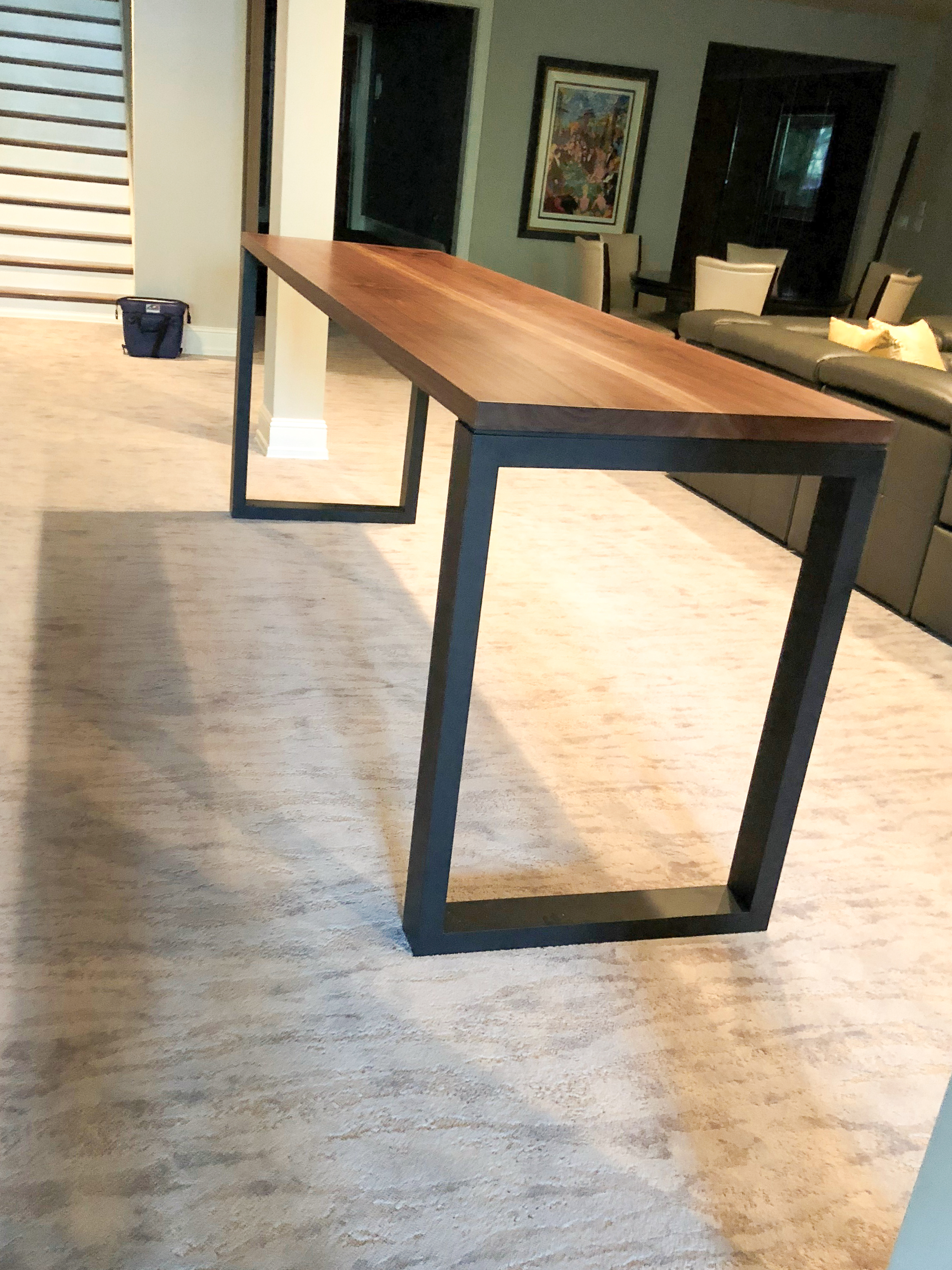 Custom walnut console table with black steel U-frame base