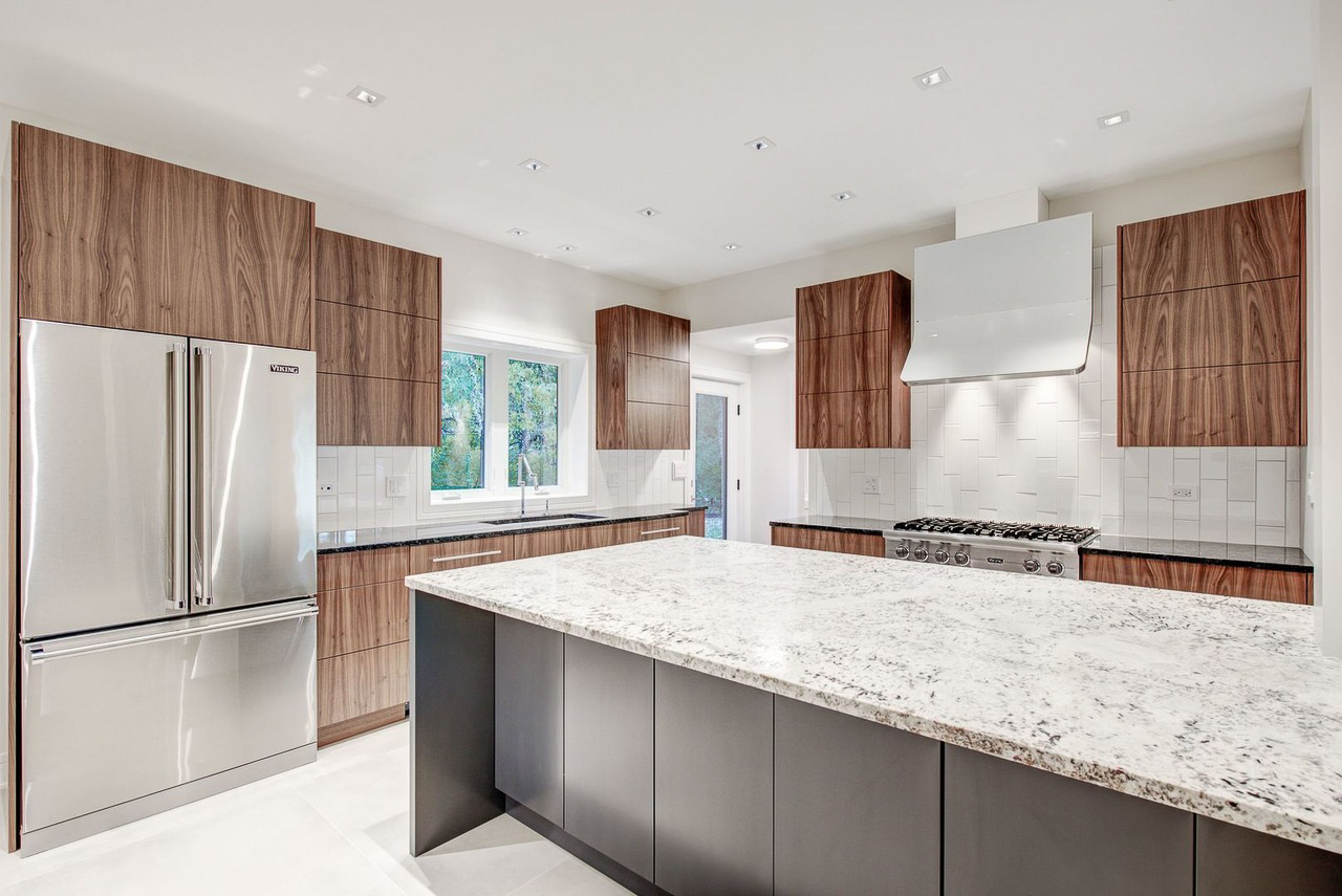 Full-height walnut cabinet wall with integrated Viking refrigerator panel
