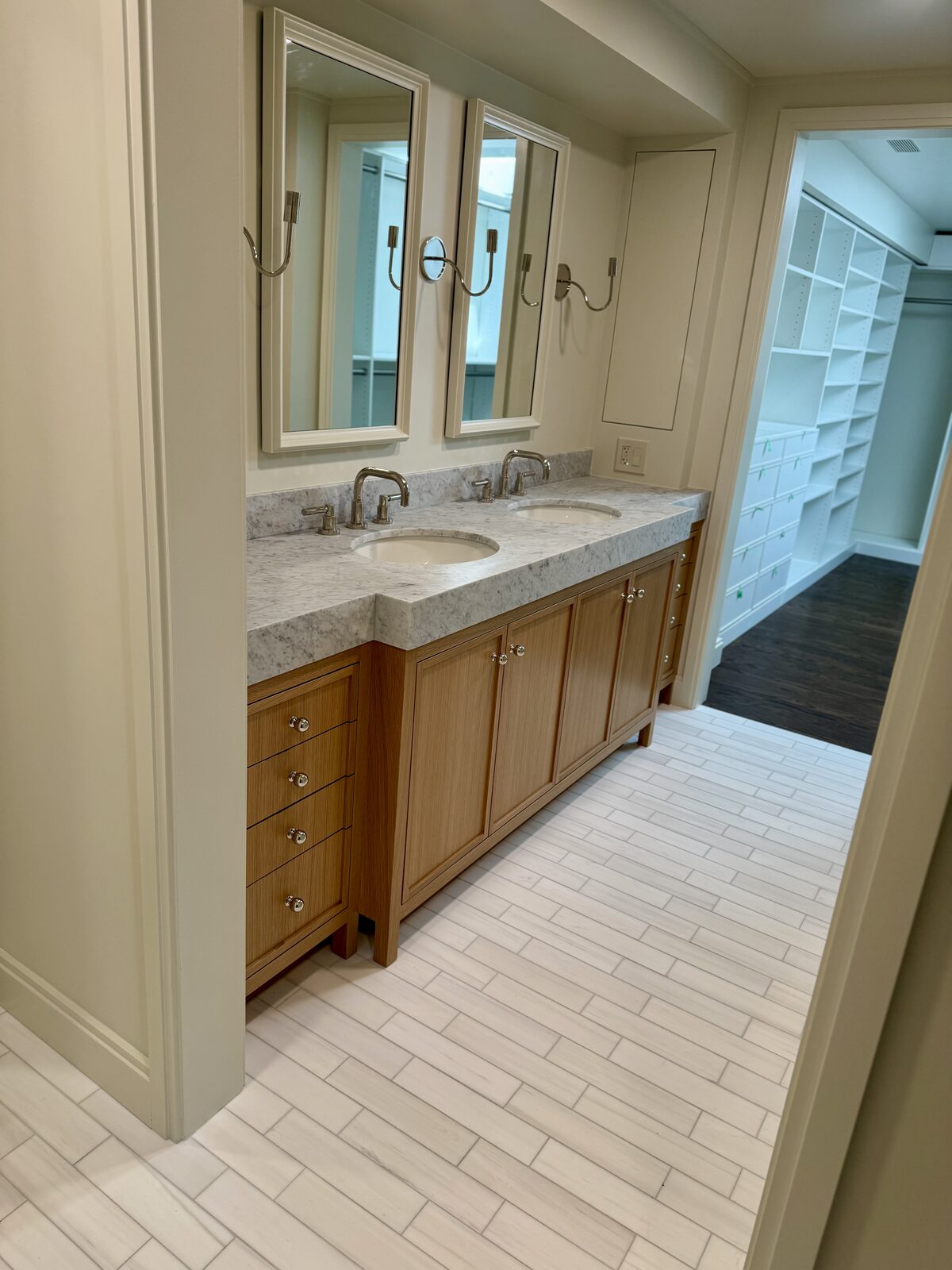 Oak fluted double-sink vanity with Calacatta marble top in walk-in closet setting